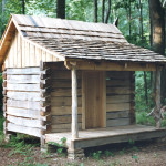 Small log cabin built from sawn 6" x 8" logs with a white oak hand spilt roof