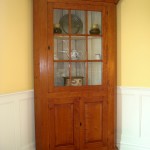 Standing curly maple cupboard with upper 9 lite glass door and 2 paneled lower doors